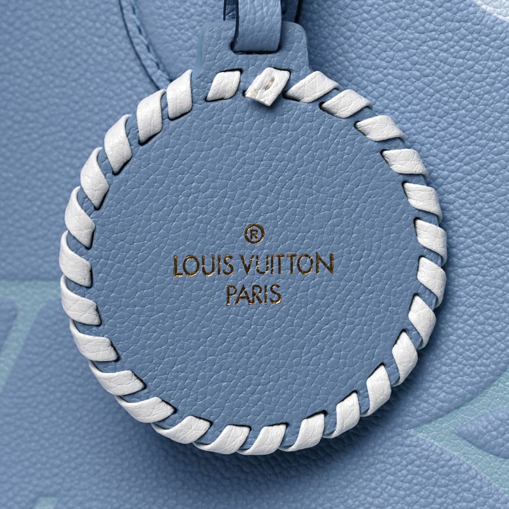 image of fake louis vuitton onthego bag charm in the color blue by FASHIONPHILE