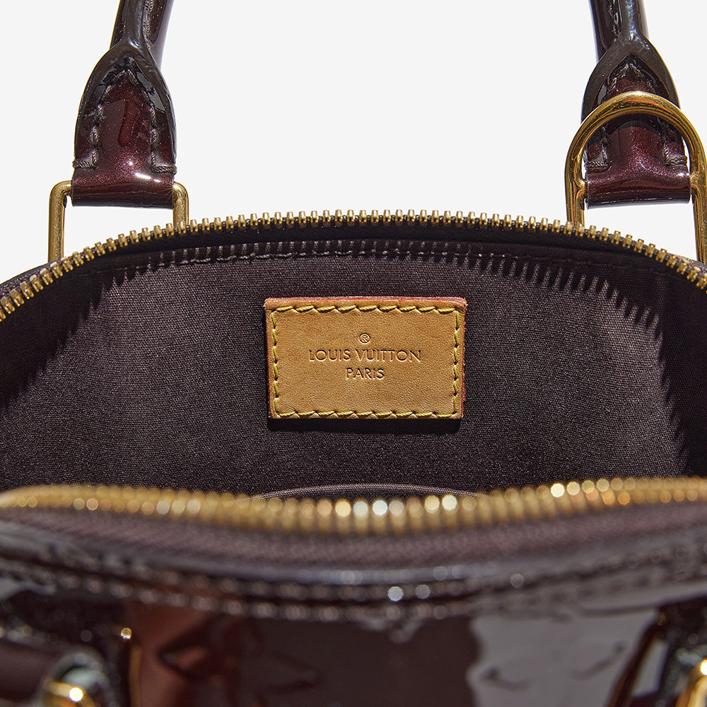 this is an image by FASHIONPHILE of an authentic louis vuitton stamp inside a vernis louis vuitton alma bb bag