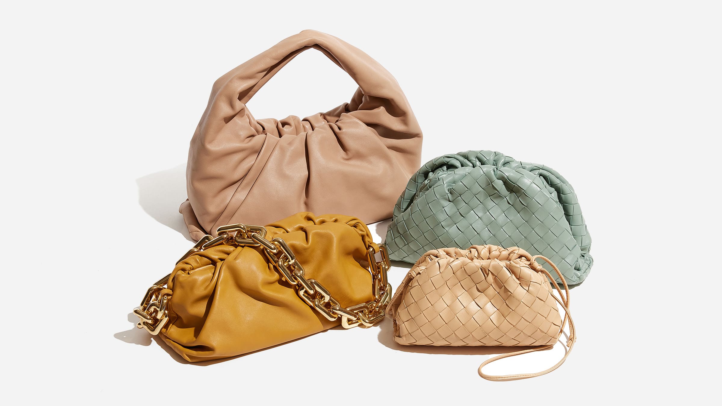 different bottega veneta pouch styles grouped together included the classic Pouch clutch, the mini pouch, the chain pouch and the shoulder pouch by FASHIONPHILE