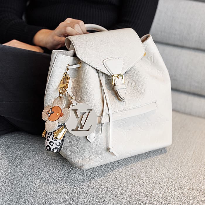 lifestyle image of model with louis vuitton backpack with louis vuitton bag charm FASHIONPHILE
