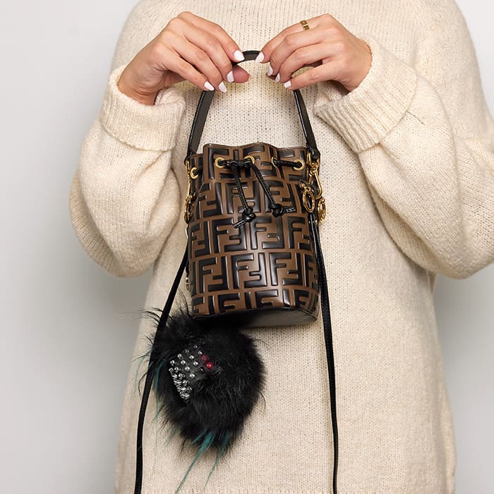 image of model wearing fendi bag with fendi fur bag charm FASHIONPHILE