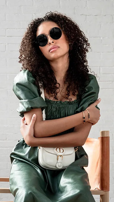 Model wearing her designer sunglasses paired with her Christian Dior bag