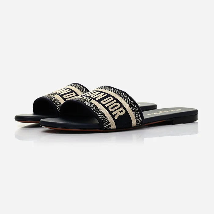 a studio photo of christian dior dway sandals blue black