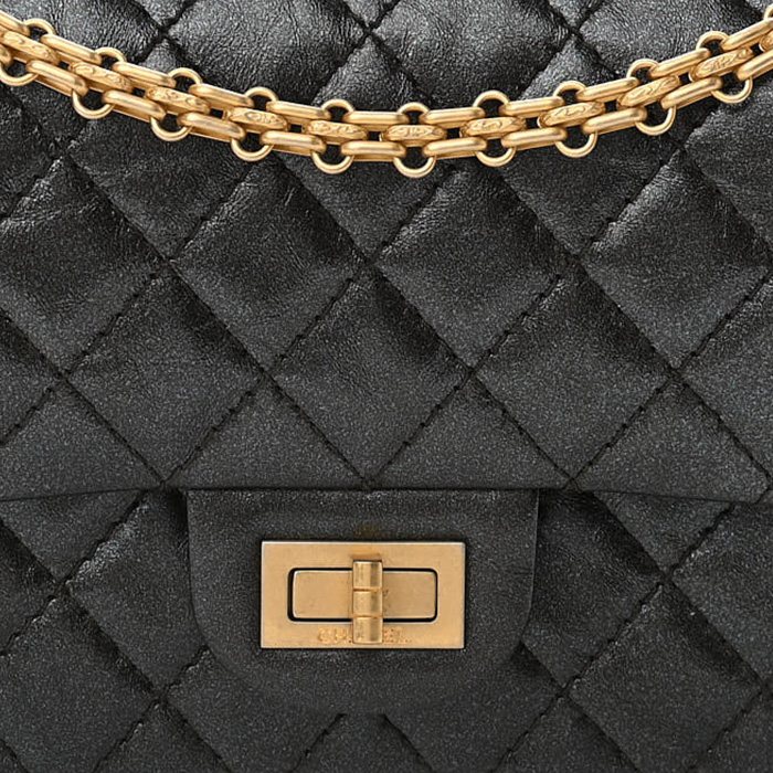 close up image of Chanel Reissue 2.55 bag in black FASHIONPHILE