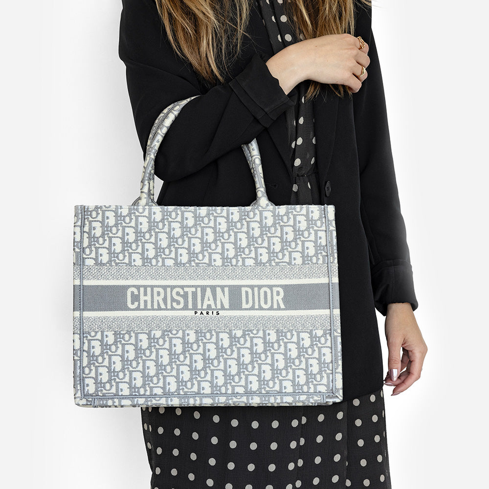 the medium book tote worn on the arm by fashionphile