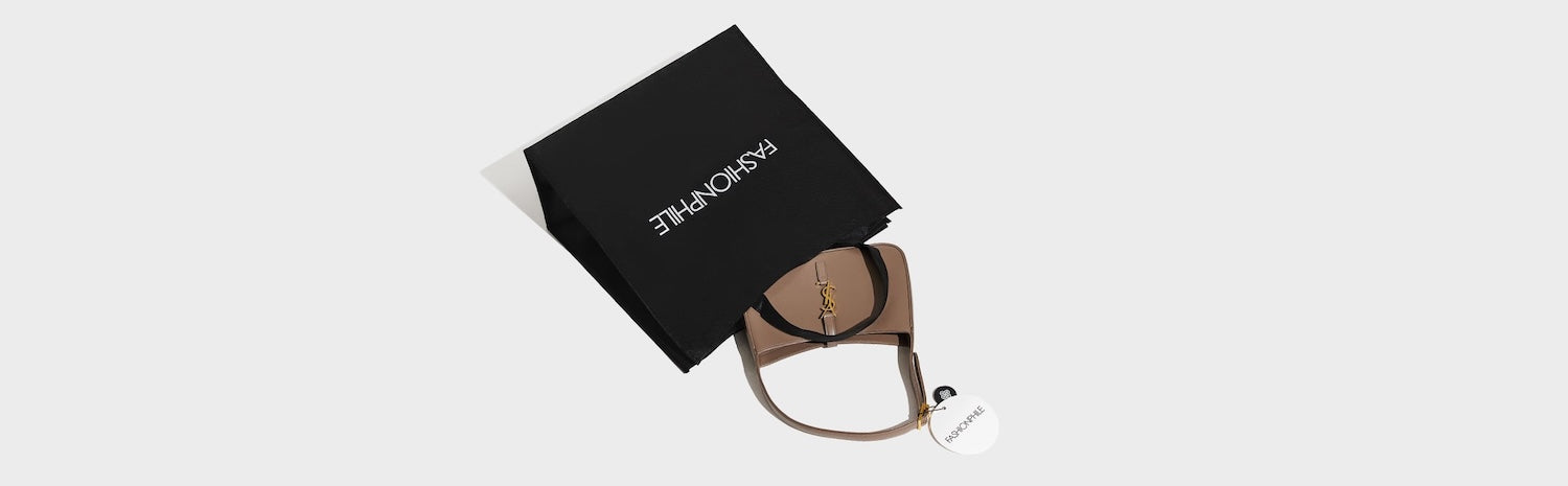 A Saint Laurent handbag with FASHIONPHILE packaging.