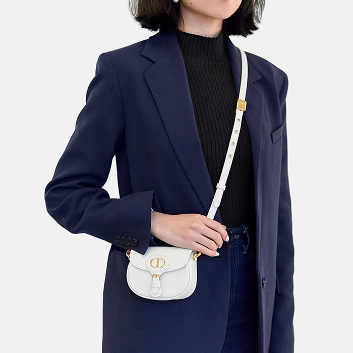the micro christian dior bobby bag in the color latte worn as a crossbody bag by FASHIONPHILE