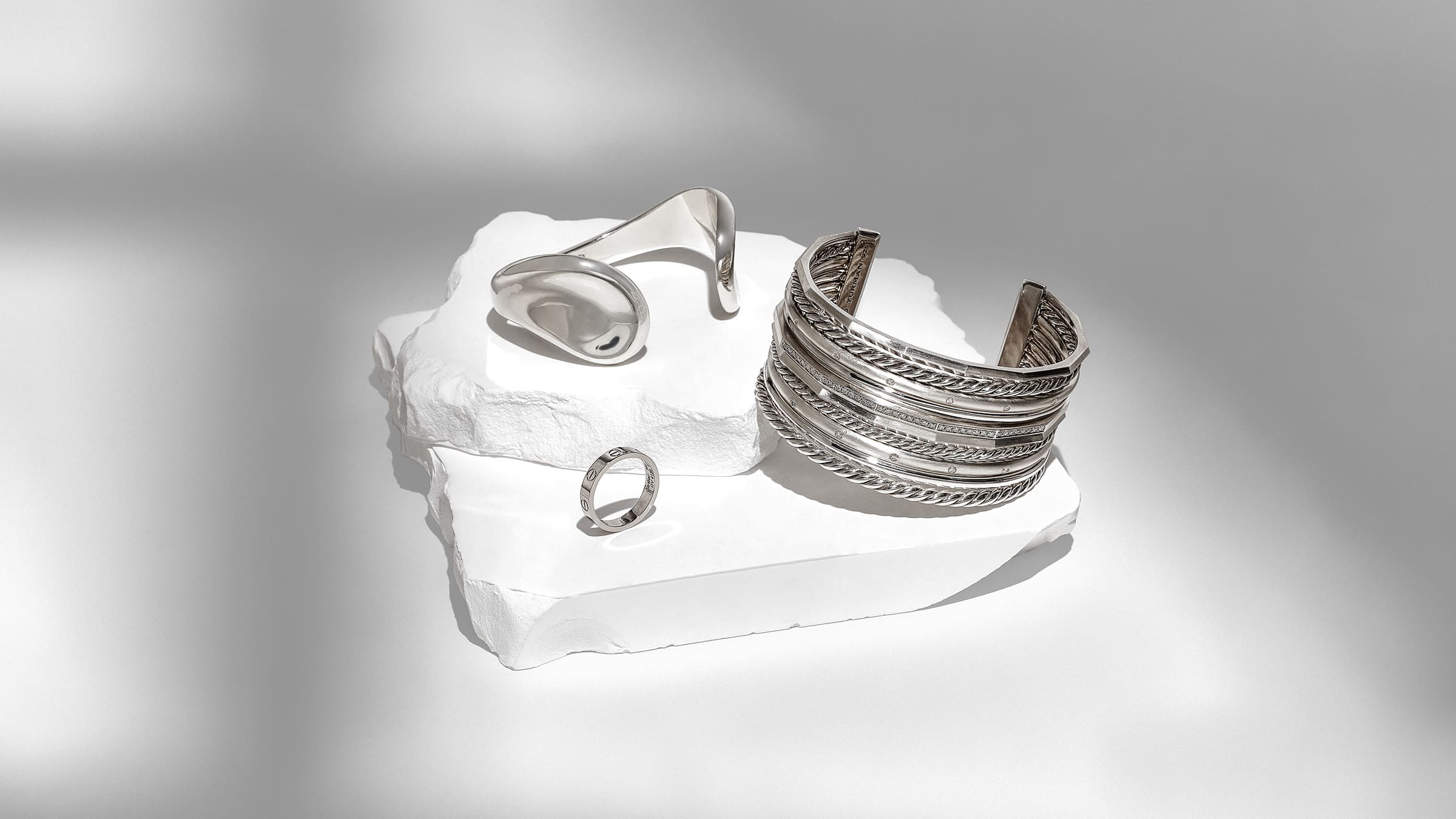 silver jewelry from tiffany, cartier, and david yurman grouped together by FASHIONPHILE