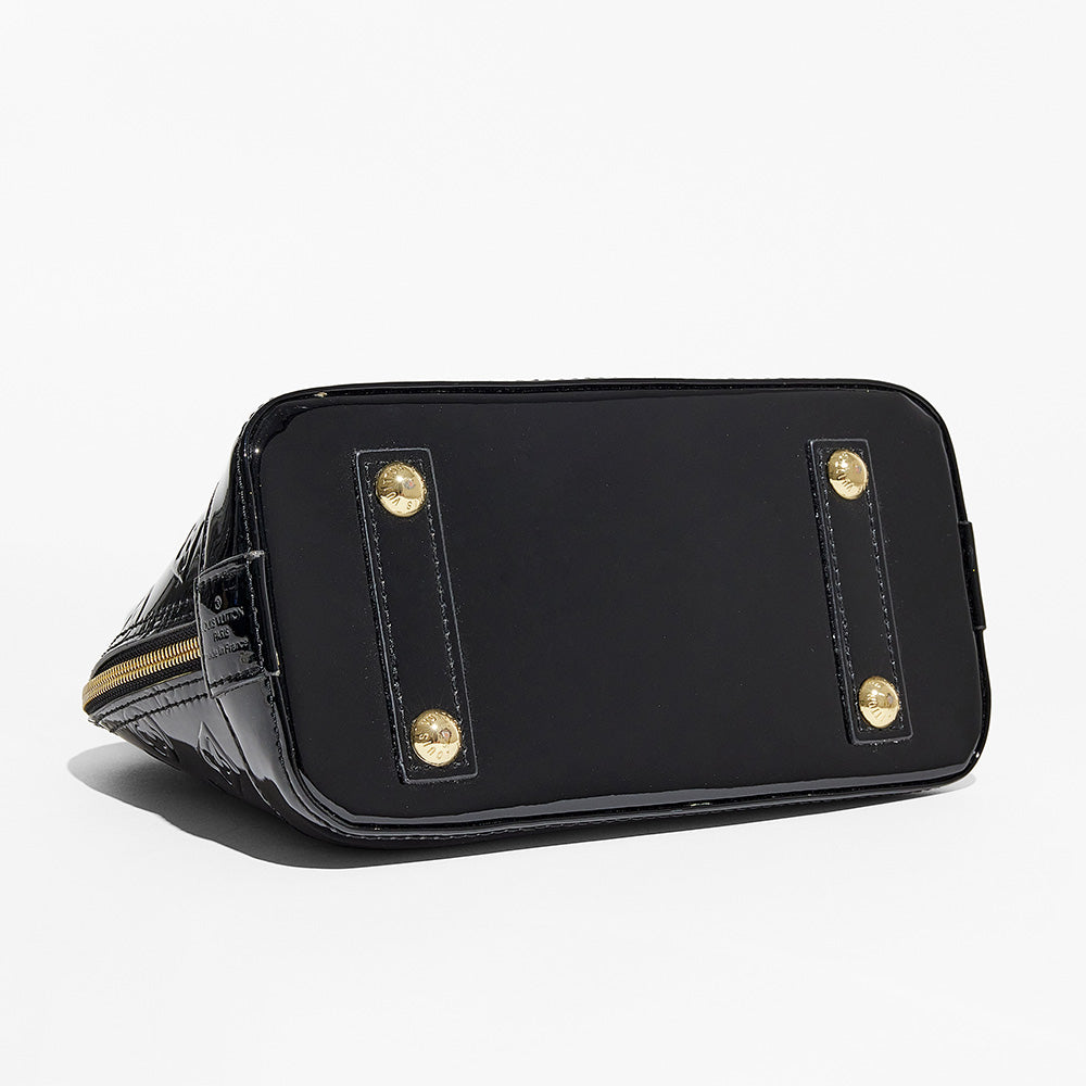 this is an image by FASHIONPHILE of a fake louis vuitton alma bag in black vernis