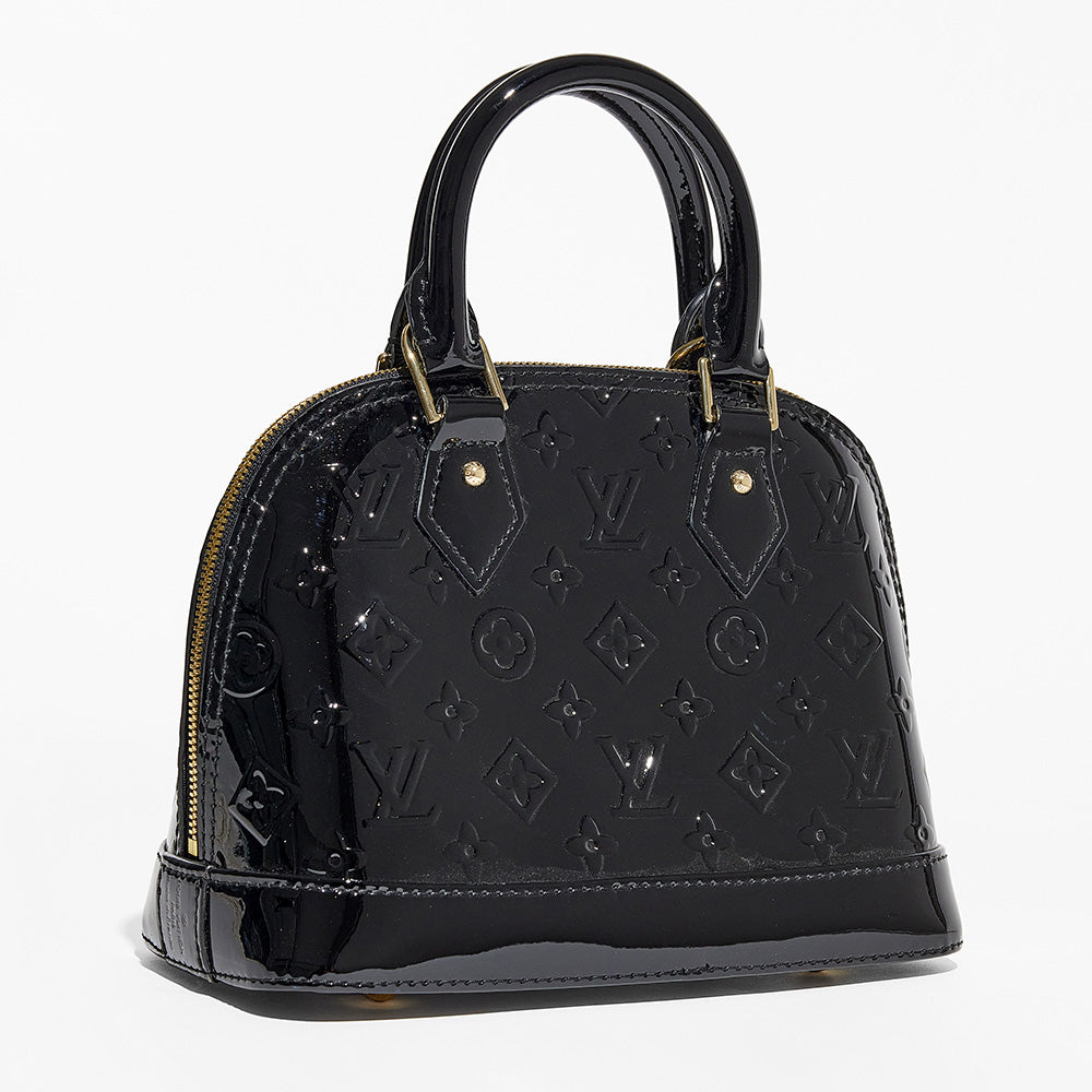this is an image by FASHIONPHILE of a fake louis vuitton alma bag in black vernis