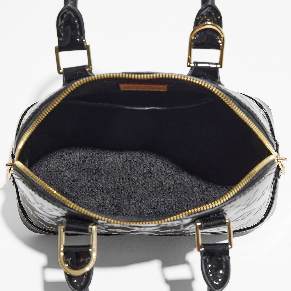 this is an interior view image by FASHIONPHILE of a fake louis vuitton alma bag in black vernis