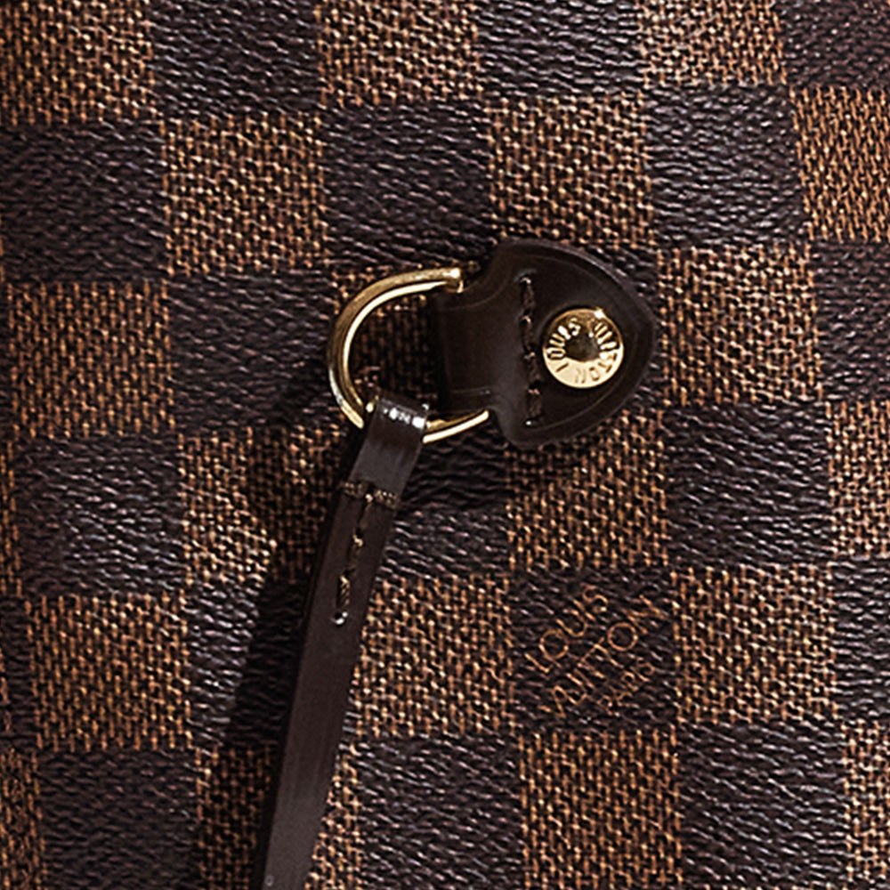 this is a close up image of a fake damier ebene louis vuitton neverfull's hardware by fashionphile