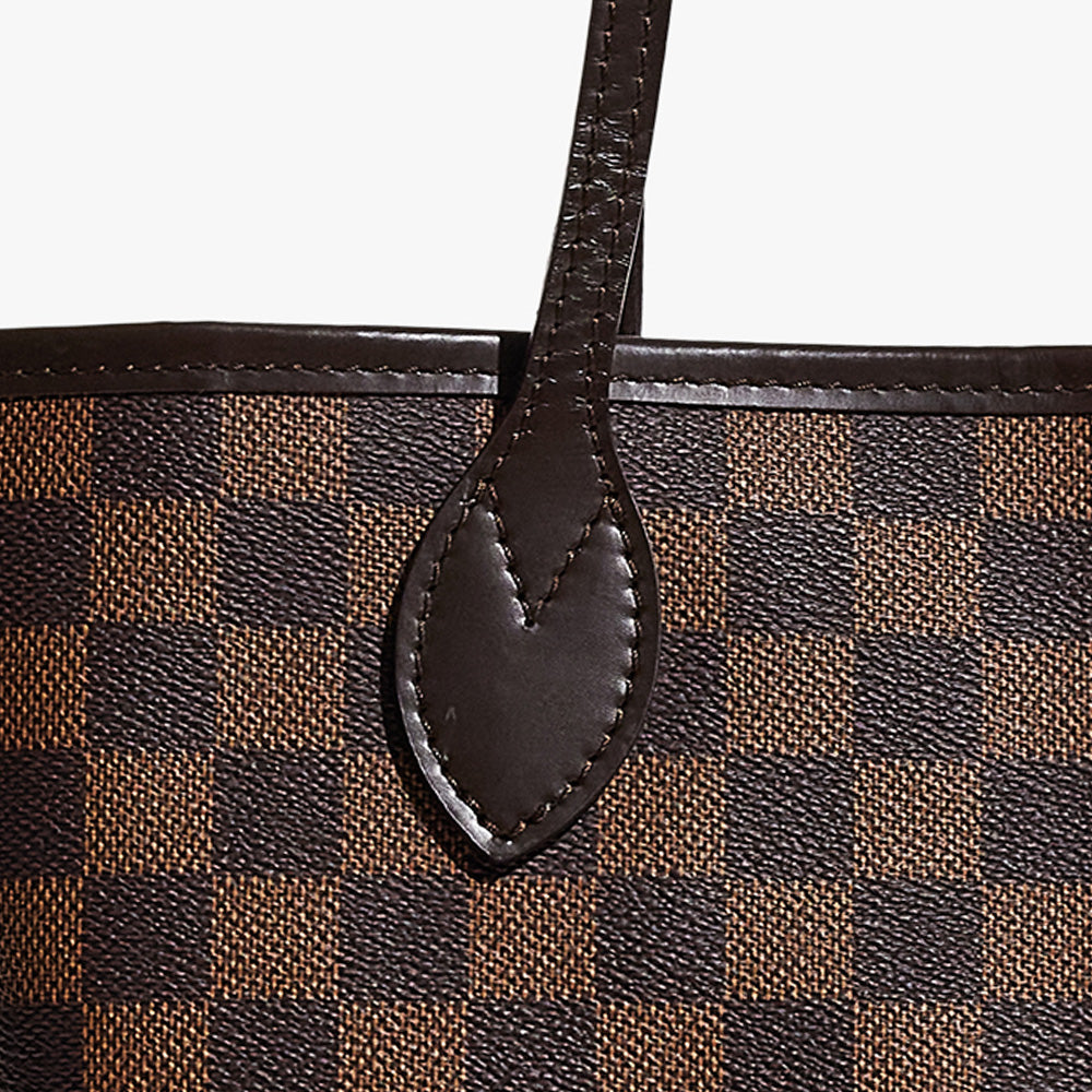 this is a close up image of a fake louis vuitton neverfull's leather and canvas by fashionphile