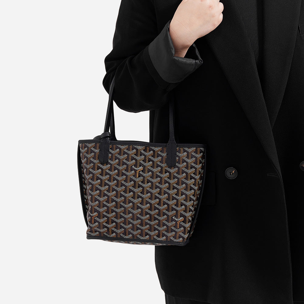model holding the goyard mini anjou tote in the color black by FASHIONPHILE