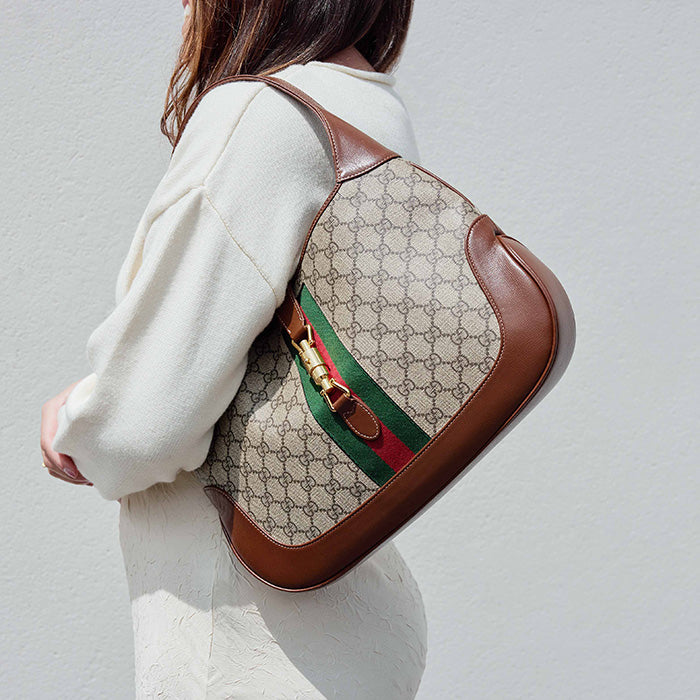 lifestyle image of model wearing the gucci medium jackie 1961 hobo bag FASHIONPHILE