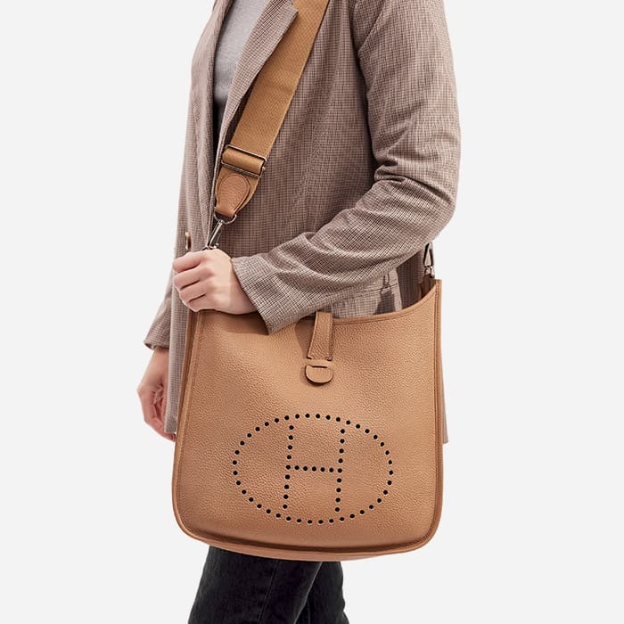 the hermes evelyne gm size worn as a shoulder bag by FASHIONPHILE