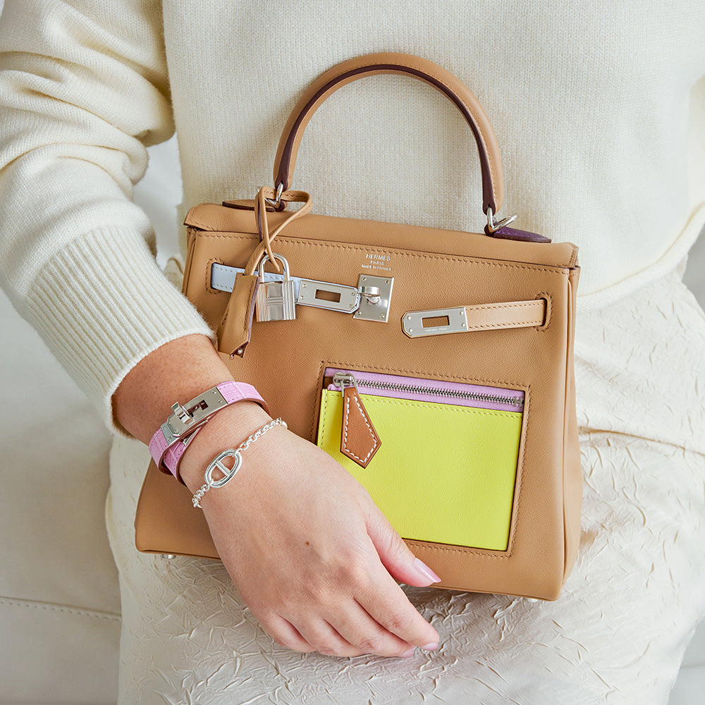 lifestyle image of girl holding herms kelly bag and wearing hermes jewelry FASHIONPHILE