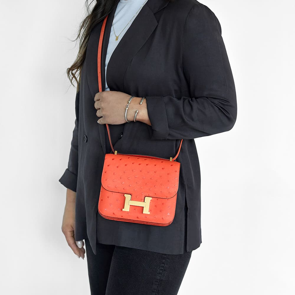the hermes constance mini 18 bag worn as a crossbody by FASHIONPHILE