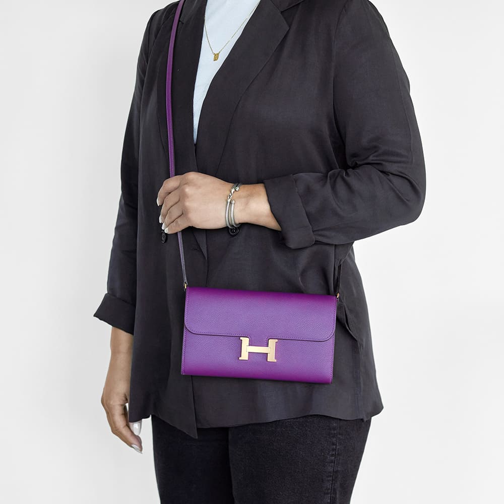 the Hermes constance wallet to go worn as a crossbody bag by FASHIONPHILE