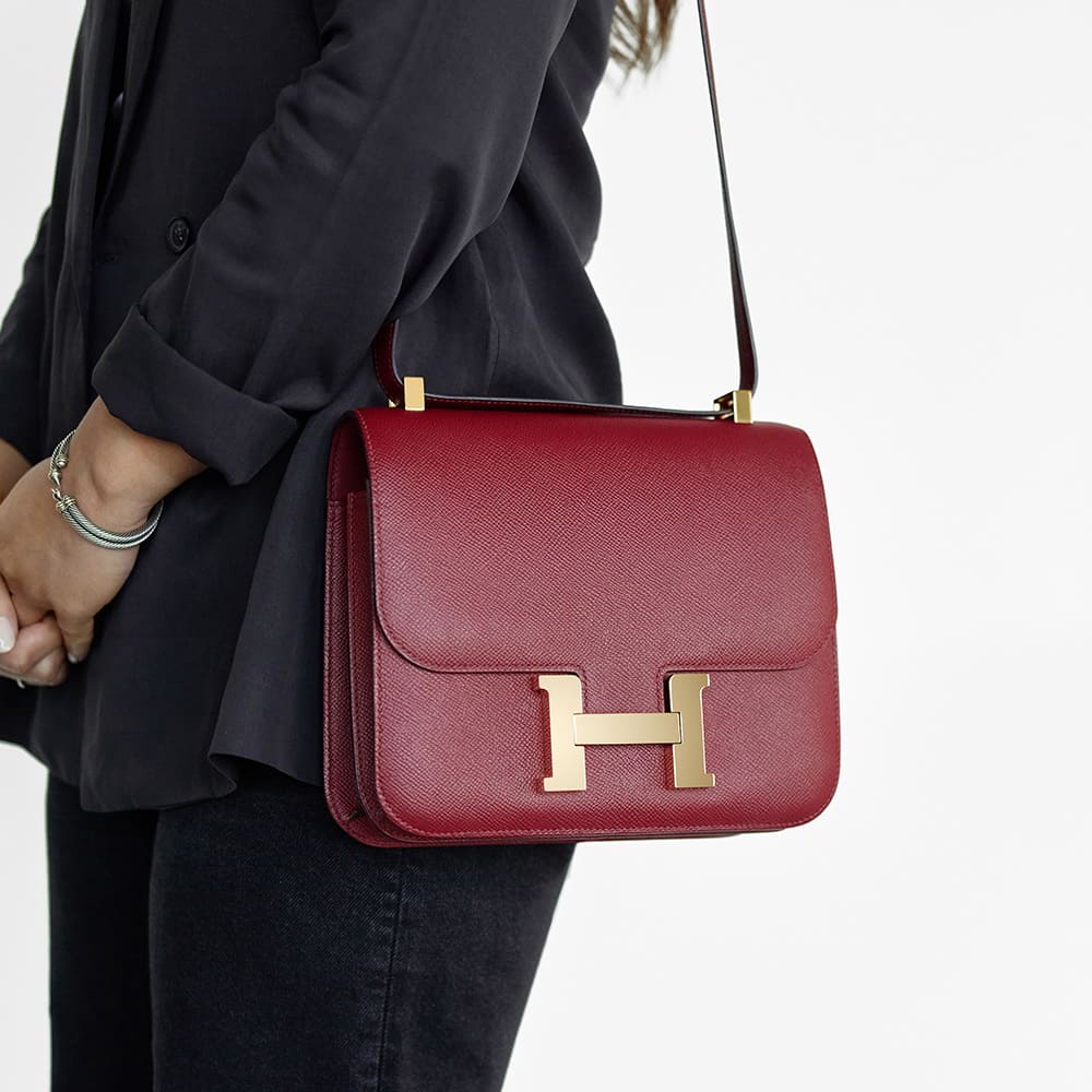the hermes constance 24 worn as a shoulder bag by FASHIONPHILE