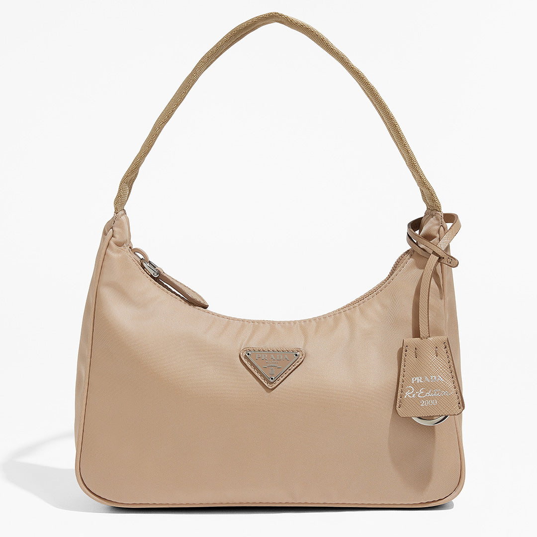 this is an image by FASHIONPHILE of an authentic Prada Mini Re-Edition bag 2000 in beige