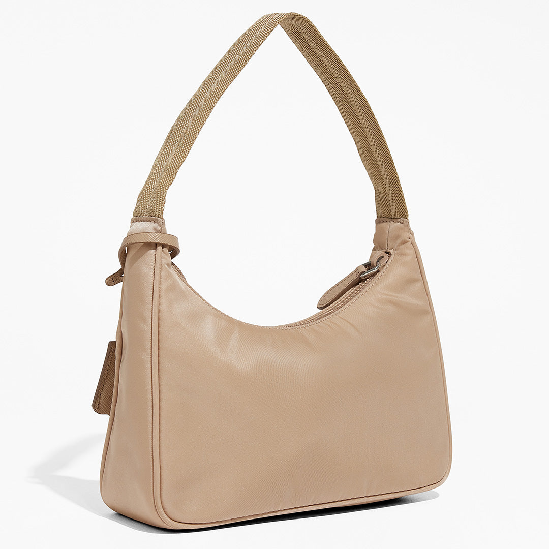 this is an image by FASHIONPHILE of an authentic Prada Mini Re-Edition bag 2000 in beige