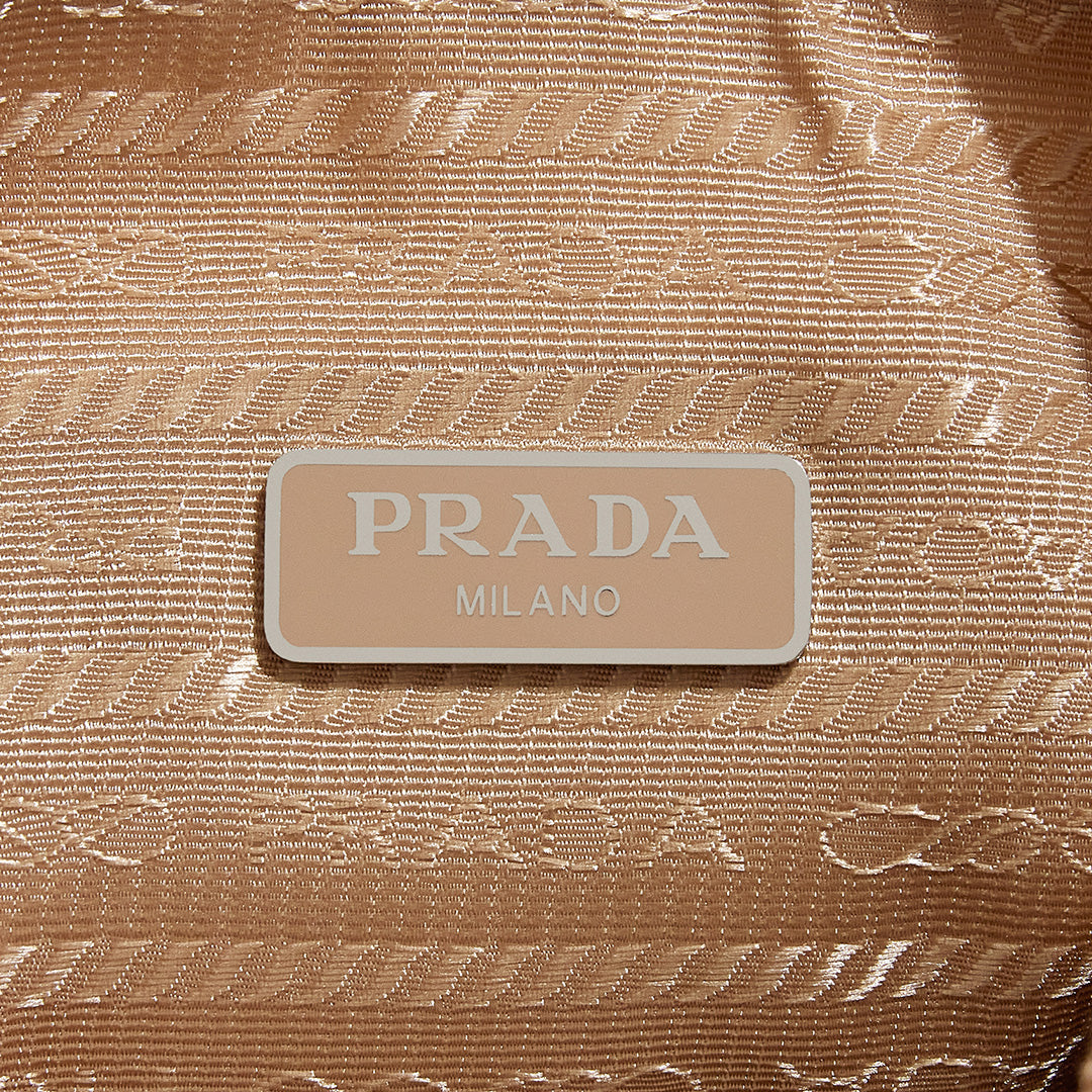 this is an image by FASHIONPHILE of an authentic Prada Mini Re-Edition bag 2000 in beige