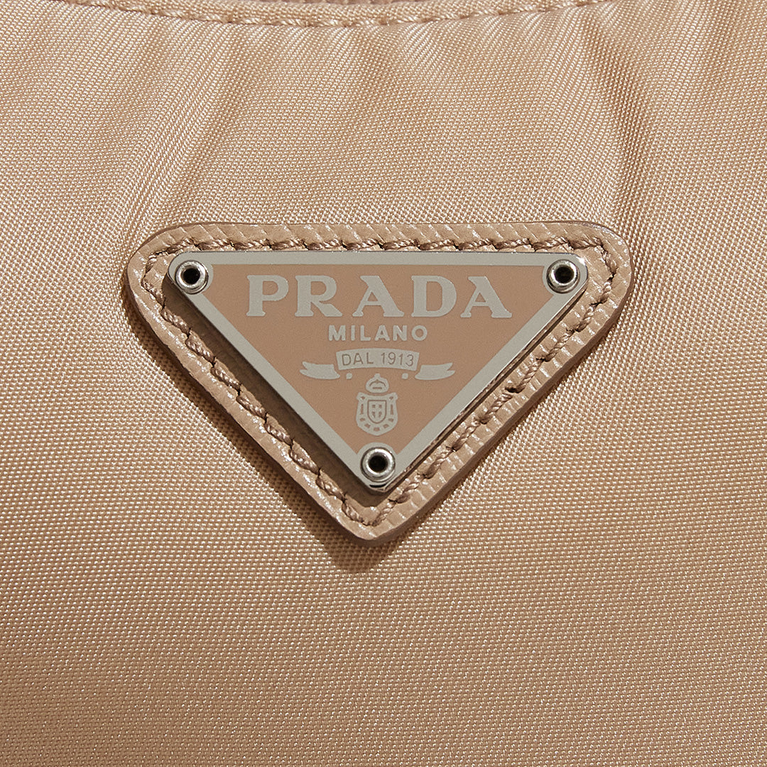 this is an image by FASHIONPHILE of an authentic Prada Mini Re-Edition bag 2000 in beige