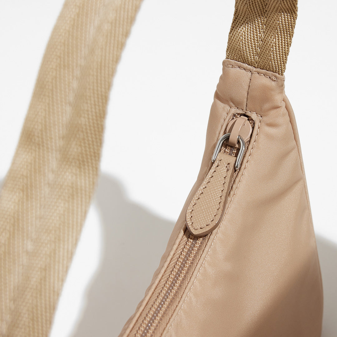 this is an image by FASHIONPHILE of an authentic Prada Mini Re-Edition bag 2000 in beige