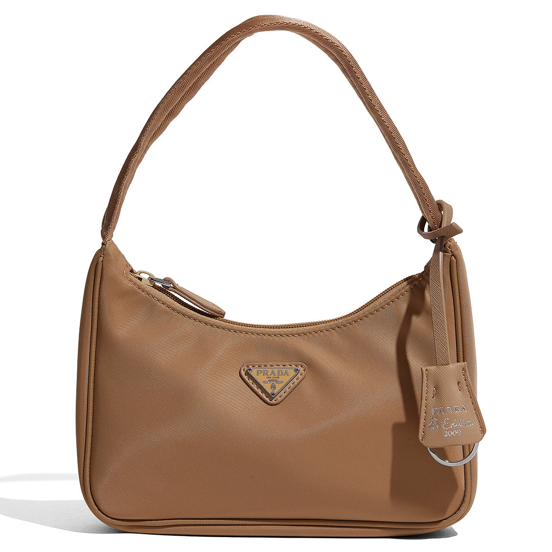 this is an image by FASHIONPHILE of a fake Prada Mini Re-Edition bag 2000 in beige