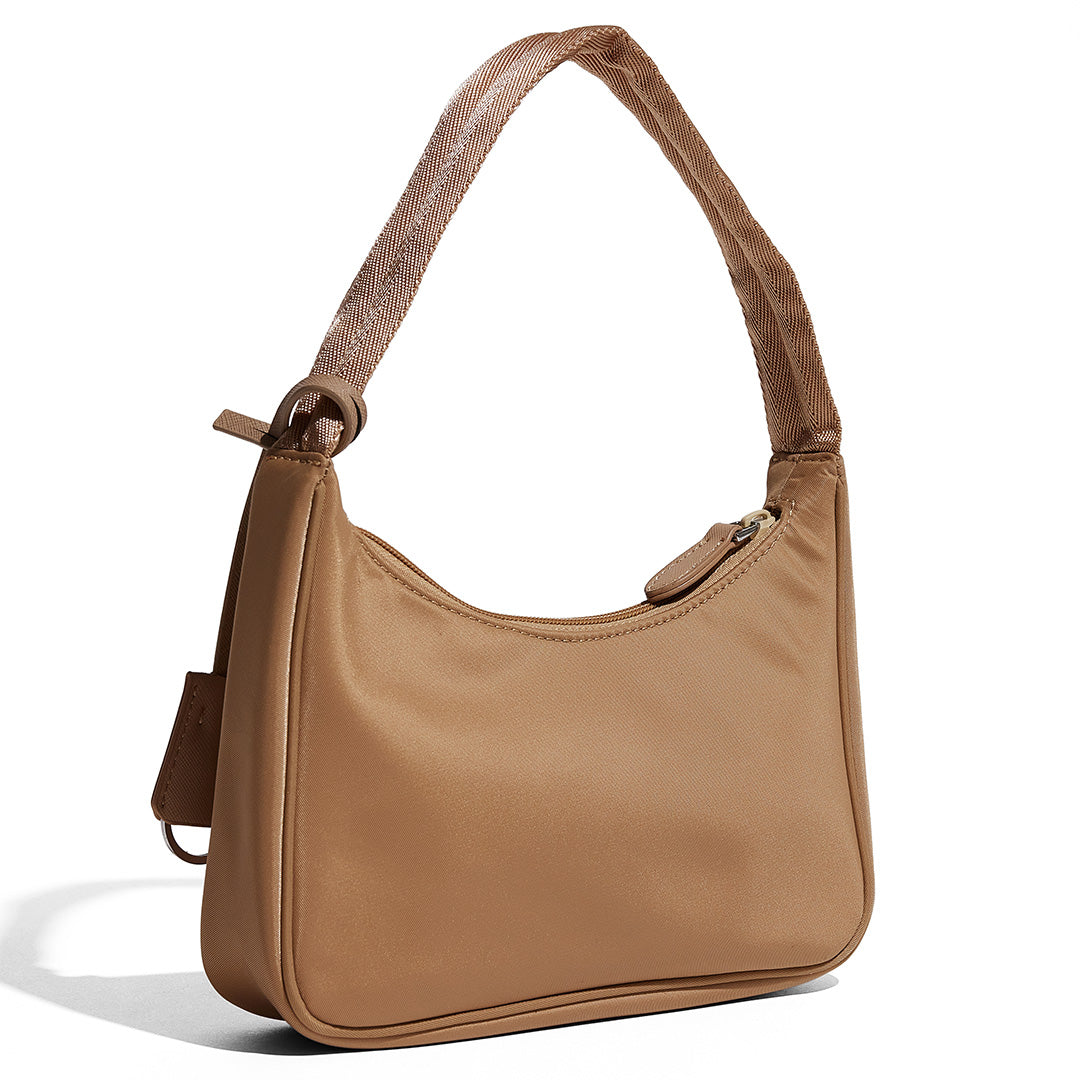 this is an image by FASHIONPHILE of a fake Prada Mini Re-Edition bag 2000 in beige