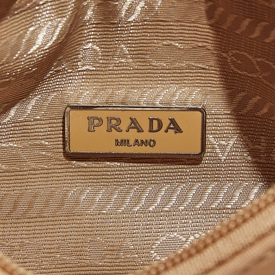 this is an image by FASHIONPHILE of a fake Prada Mini Re-Edition bag 2000 in beige