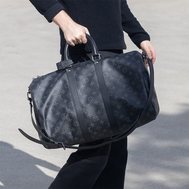 lifestyle image of influencer wearing louis vuitton monogram eclipse keepall bag FASHIONPHILE