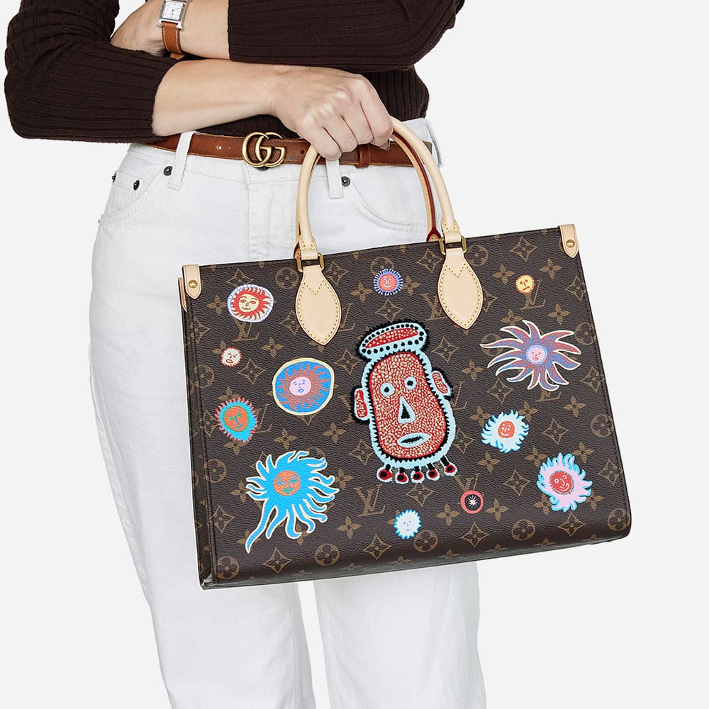 a classic monogram louis vuitton onthego tote in collaboration with yayoi kusama in size mm worn as a top handle bag by FASHIONPHILE