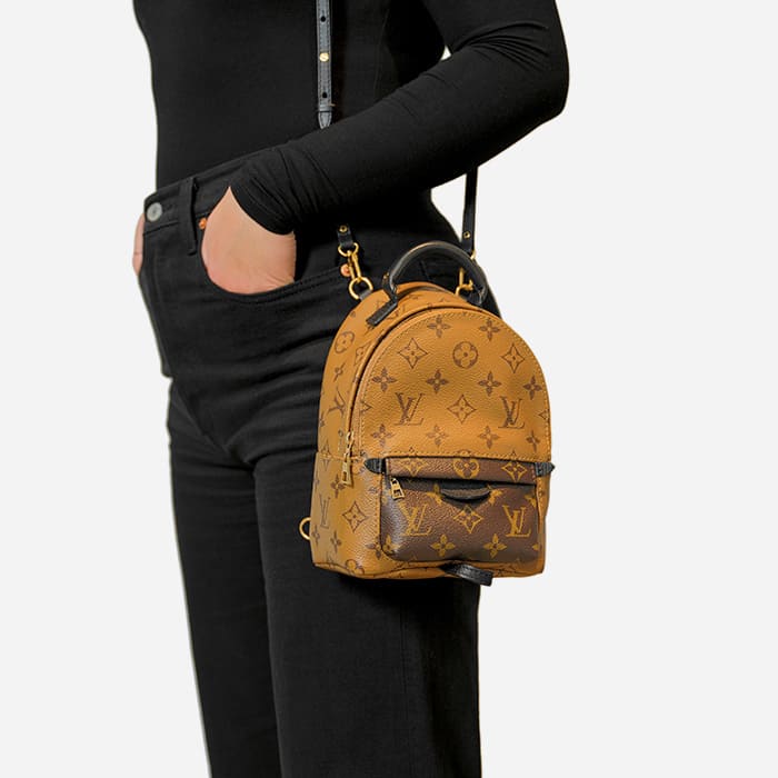 ways to wear the louis vuitton mini palm springs backpack with model wearing it as a shoulder bag by FASHIONPHILE