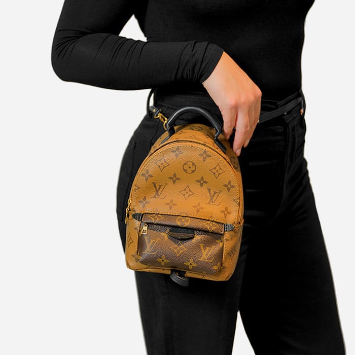 ways to wear the louis vuitton mini palm springs backpack with model wearing it as a belt bag by FASHIONPHILE