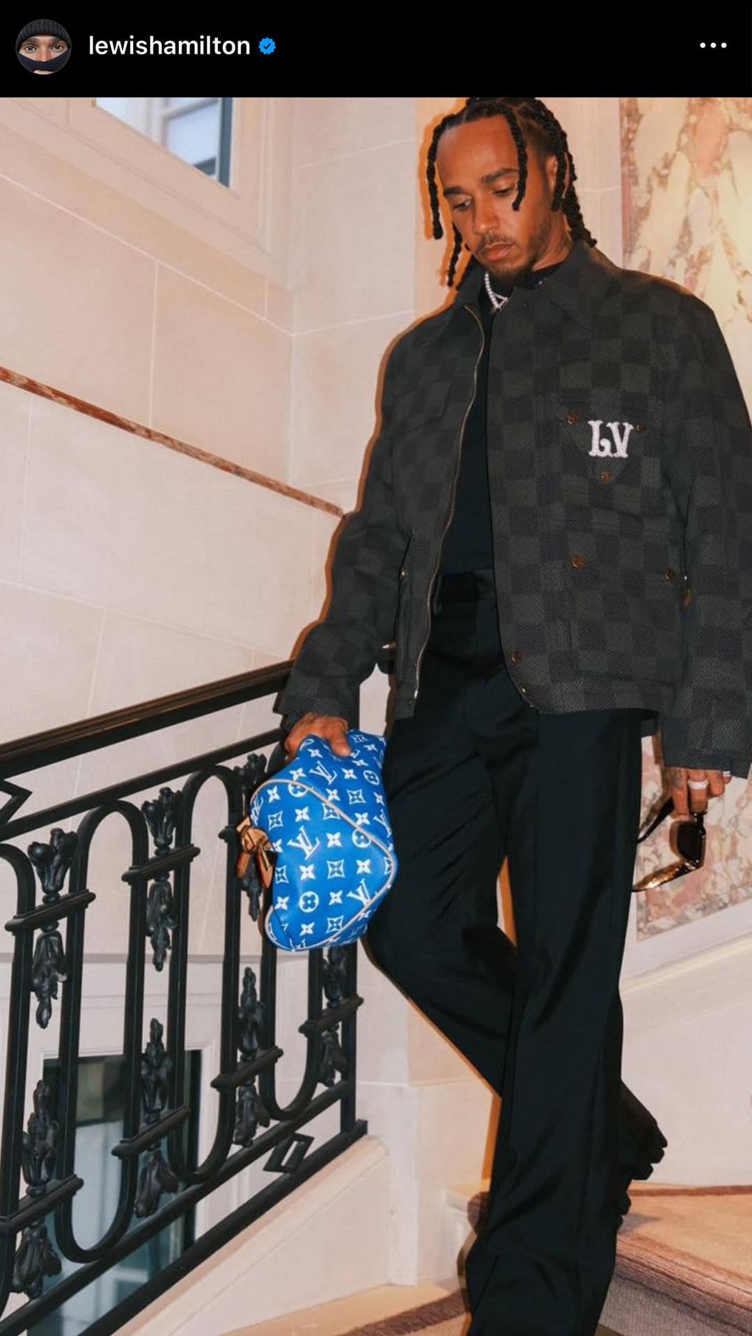 screenshot image of lewis hamilton wearing his blue leather monogram louis vuitton speedy bag at pharrell williams' lv show