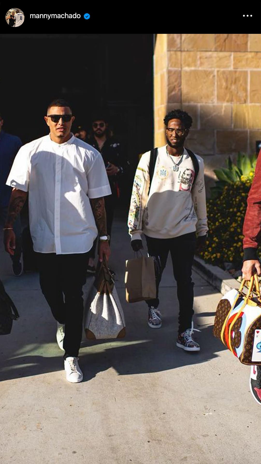 screenshot image of manny machado's instagram of the san diego padres wearing designer duffle bags on the way to the game by FASHIONPHILE