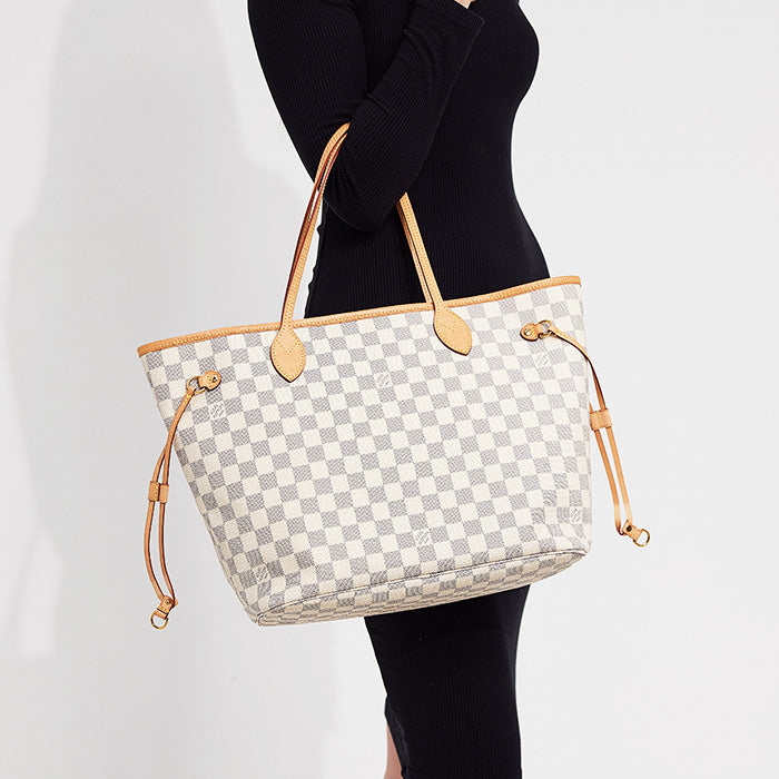 lifestyle image of model wearing louis vuitton neverfull mm tote FASHIONPHILE