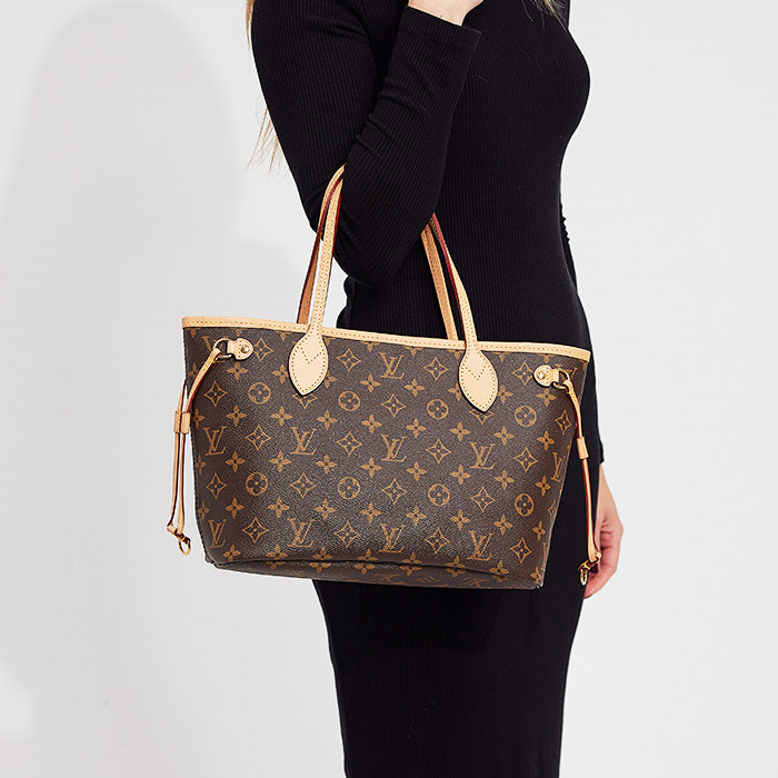 lifestyle image of model wearing louis vuitton neverfull pm tote FASHIONPHILE