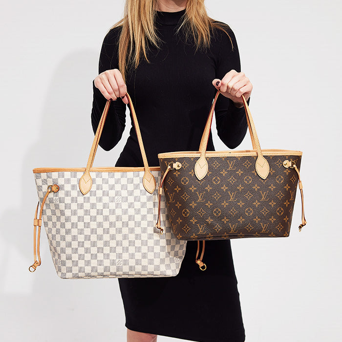 lifestyle image of model holding louis vuitton neverfull pm tote and louis vuitton neverfull mm tote side by side FASHIONPHILE