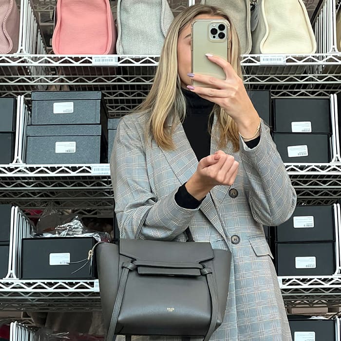 image of fashionphile personal shopper taking selfie with designer bag in the cage