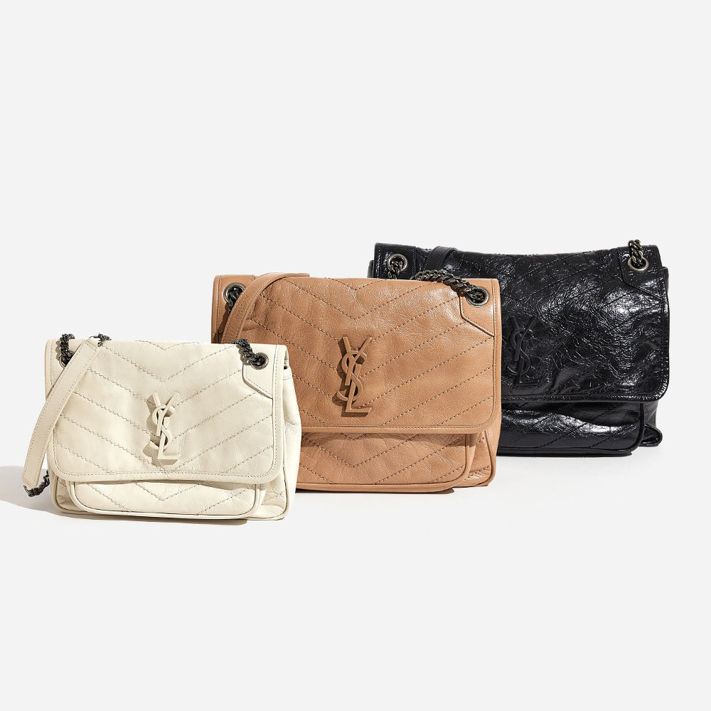 this is an image of all three saint laurent niki chain satchel sizes lined up side by side by FASHIONPHILE