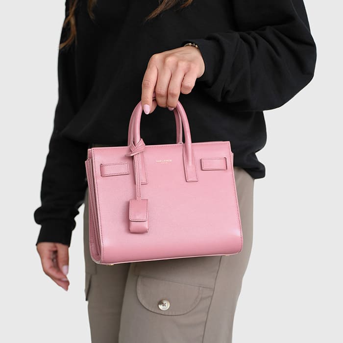 pink nano sac de jour worn as a top handle bag by FASHIONPHILE