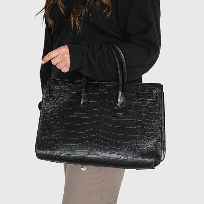 black crocodile embossed leather medium sac de jour styled on the arm by FASHIONPHILE