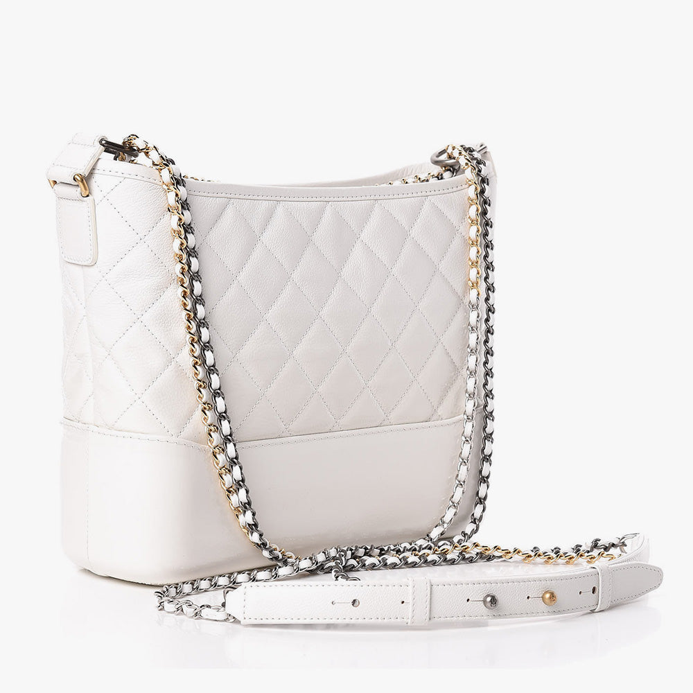 this is a side view image of an authentic white chanel gabrielle hobo bag by fashionphile