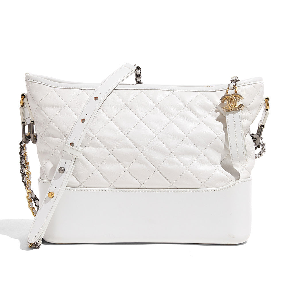 this is a front view image of a fake white chanel gabrielle hobo bag by fashionphile