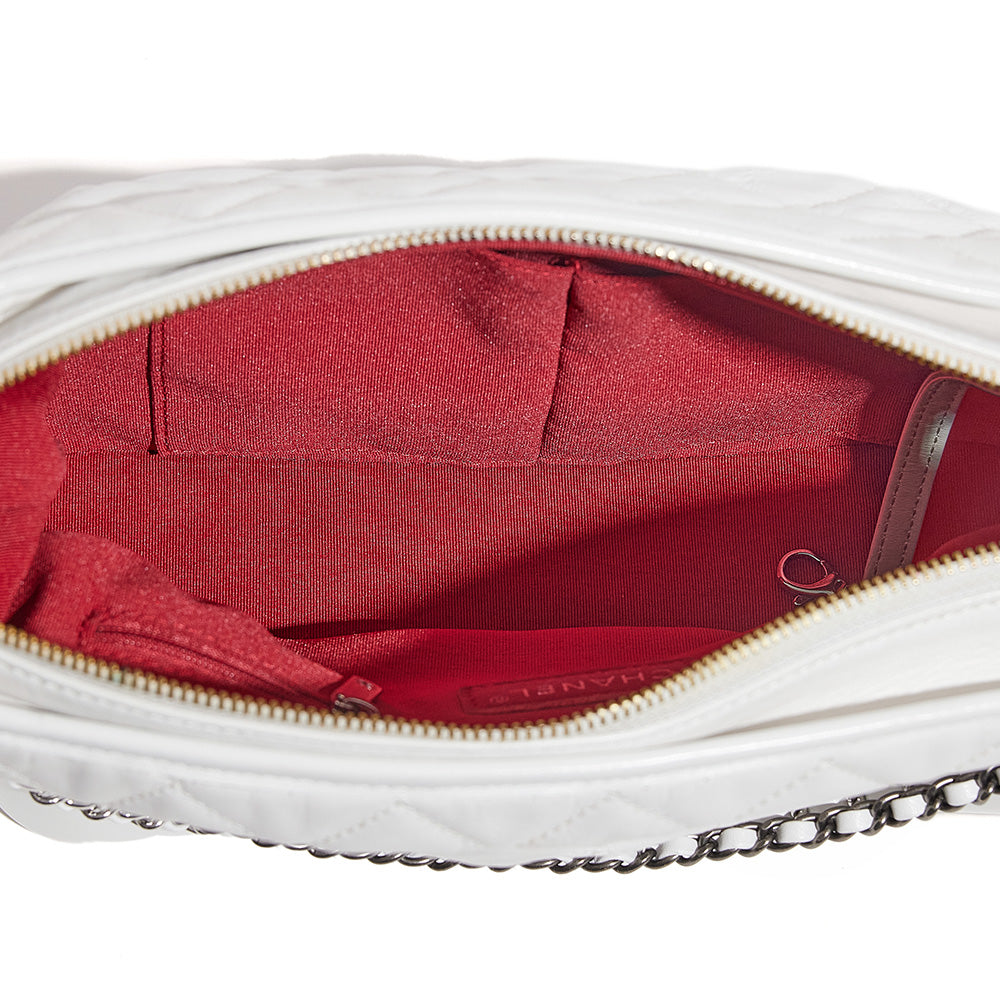 this is a top down view image of a fake white chanel gabrielle hobo bag showing the fake lining by fashionphile