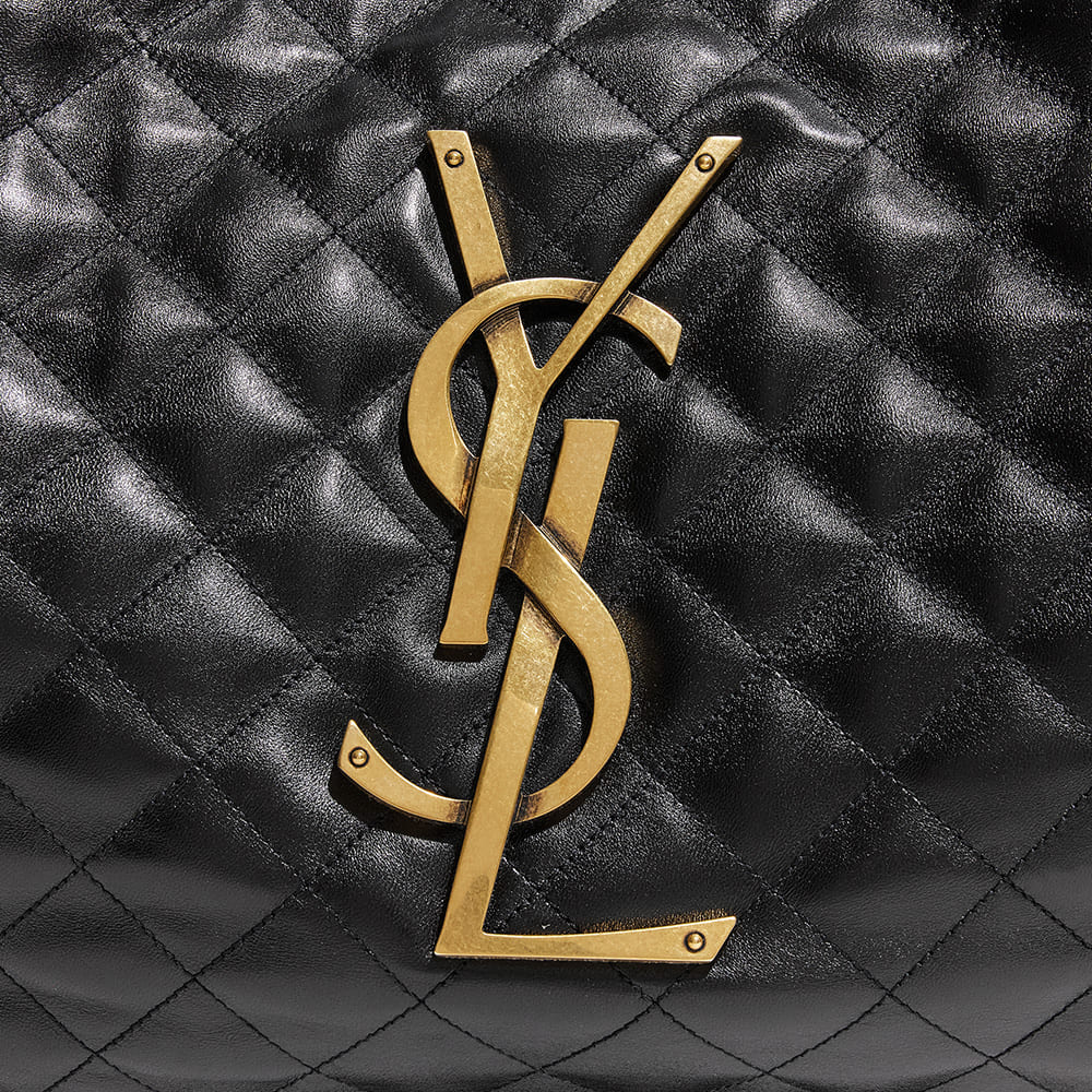 the side view image of an authentic saint laurent icare maxi shopping tote showing the gold YSL logo hardware by FASHIONPHILE