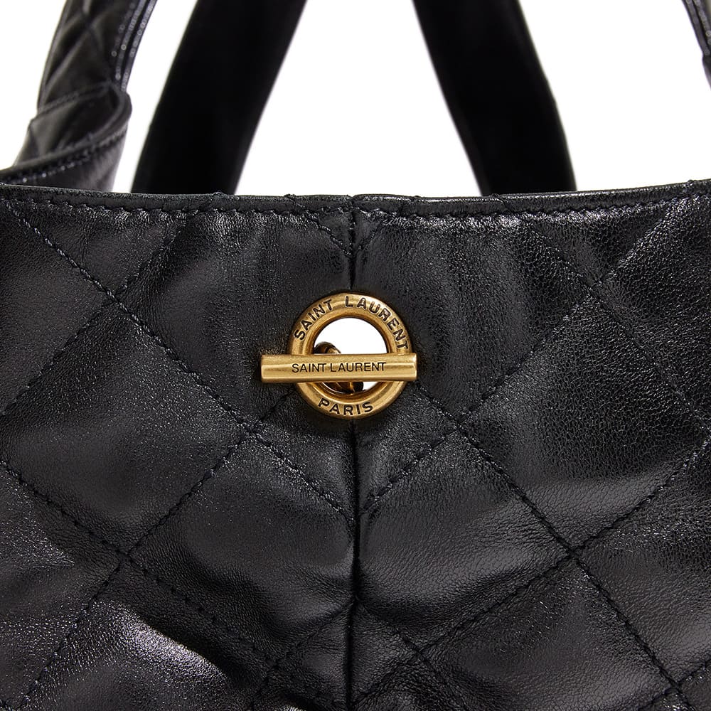 the side view image of an authentic saint laurent icare maxi shopping tote showing the branded gold hardware by FASHIONPHILE